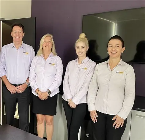 Four Management Support consultants in branded shirts